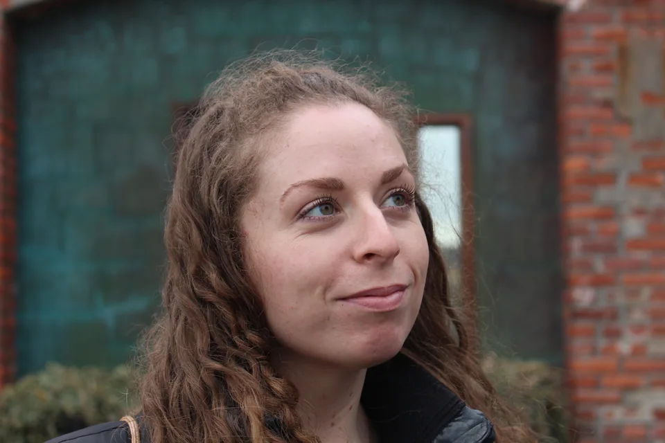 An outdoor portrait of a person looking to the side